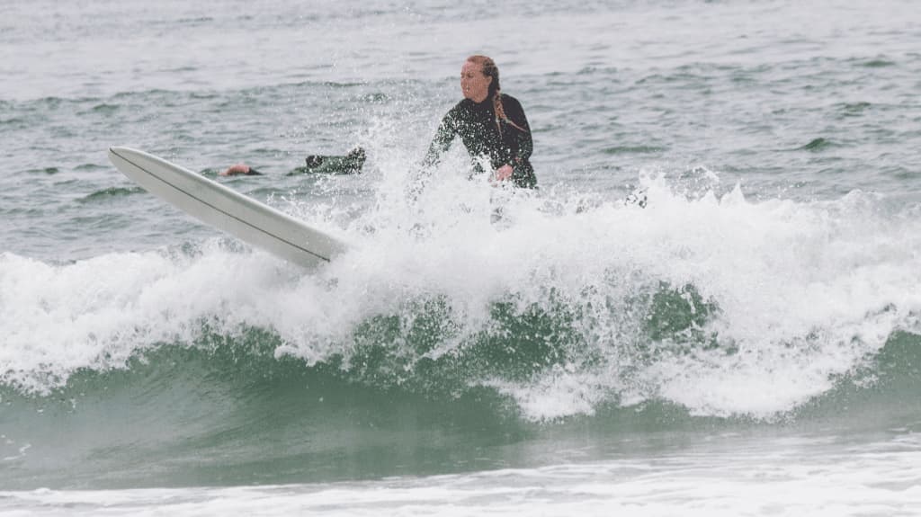 a surfer wiping out on a breaking wave