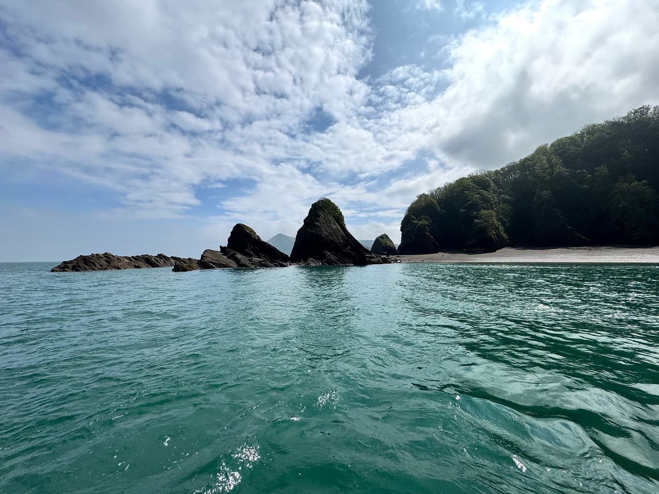 turquoise sea and rocky islets under a cloudy sky